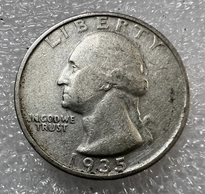 1935 Washington quarter off-center strike error showing design shifted from center with visible blank planchet area and date still readable